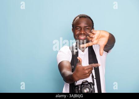 Happy man making rectangle shape with fingers Stock Photo - Alamy