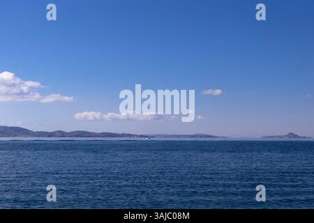 View of the grandeur of Lake Titicaca and the distant shores in Puno, Peru Stock Photo