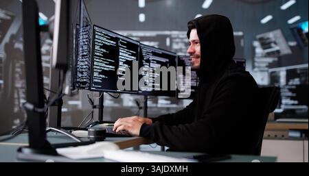 Celebrating A Win, The Young Latino Hacker Cheers At His Screen. Stock Photo