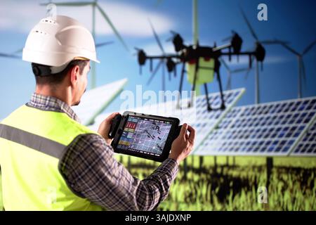 Man In Field With Solar Panels, Drone Flying Overhead For Inspection Stock Photo