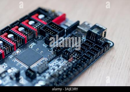 This image showcases a detailed closeup of a computer motherboard placed neatly on a rustic wooden table, highlighting intricate designs Stock Photo