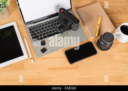 Two sd memory cards and lens on gray background. Photographer's equipment. Top view. Flat lay. Laptop, external hard drive, modern digital camera with Stock Photo