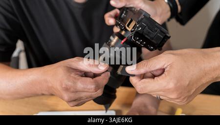 DSLR camera while working in home office. Photographers at their studio. Mature professional photographer working at home. Male photographer ready to Stock Photo