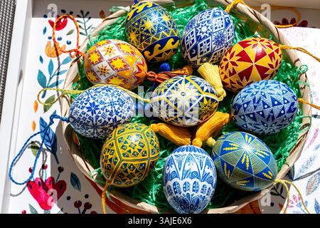 A vibrant assortment of Easter eggs showcases traditional Ukrainian pysanky techniques, exhibiting intricate folk patterns. Arranged beautifully in a Stock Photo