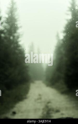 raindrops on the windshield of a car, in the blurred background an autumn forest on a country road in Ravna Romanija, Bosnia And Herzegovina (2) Stock Photo