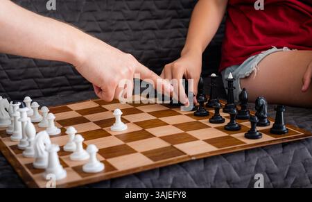 Playing Chess On A Sofa At Home For A Weekend Activity Stock Photo