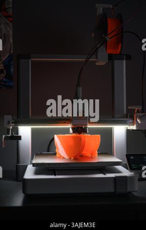 3D Printer Creating Vibrant Orange Prototype Model Stock Photo