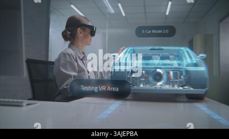 Female Automotive Engineer Wearing Headset Uses Augmented Reality Hologram to Create 3D High-Tech Electric Vehicle on Li-Ion Battery. Renewable Energy Car Design. Advanced Artificial Intelligence. Stock Photo