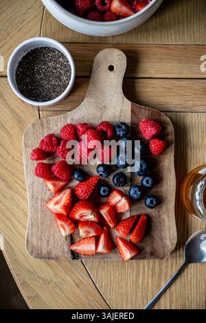 Fresh berries on a cutting board, making smoothie Stock Photo