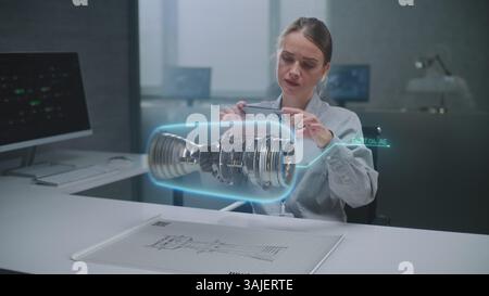 Female Engineer Uses Smartphone to Visualize 3D Holographic Model of Renewable Energy Engine in Futuristic Office. Advanced AI-based Design Software for Virtual Visualization Using Augmented Reality. Stock Photo