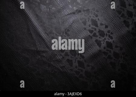 top view of black fake snakeskin. Vegan leather texture Stock Photo