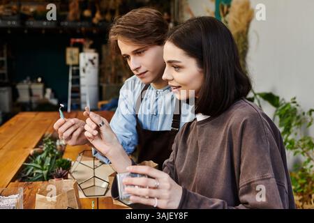 Creative couple collaborate to create unique art pieces and explore their creativity. Stock Photo