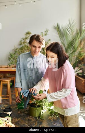 Creative couple collaborate on a project, nurturing plants and sharing inspiration. Stock Photo