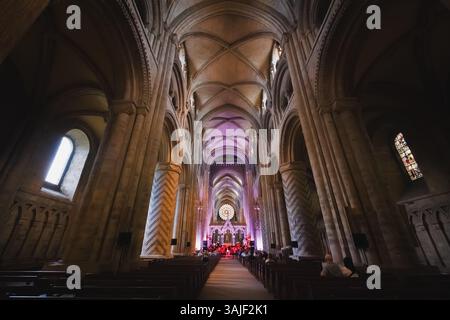 Durham, UK - June 22, 2024: The ornate and vaulted interior of Durham Cathedral showcasing its historic Norman architecture and grand nave, a famous B Stock Photo
