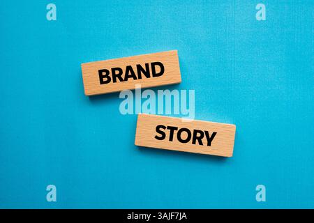 Brand story message written on wooden blocks on blue background. Conceptual brand story symbol. Copy space. Stock Photo