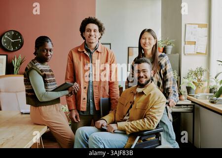 Portrait of talented and young group of developers and programmer posing for group photo in comfortable but modern office of IT company Stock Photo