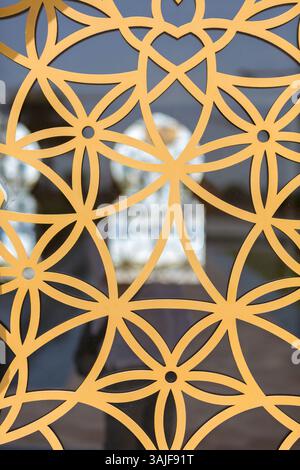 Golden geometric pattern of overlapping circles and lines against a blurred background. Stock Photo