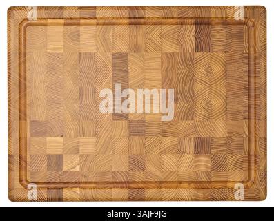 Top down view of a rectangular wooden cutting board made of end grain construction, showcasing a mosaic of wood patterns and a carved juice groove aro Stock Photo
