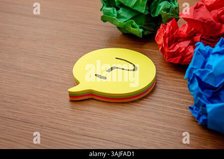 Speech bubble with a question mark and crumpled paper. Questions, ideas, brainstorming, or problem-solving concept. Stock Photo