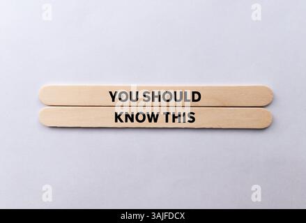 You should know this message written on wooden sticks on white background. Conceptual you should know this symbol. Copy space. Stock Photo
