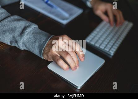 Desk and hands of a young programmer Stock Photo
