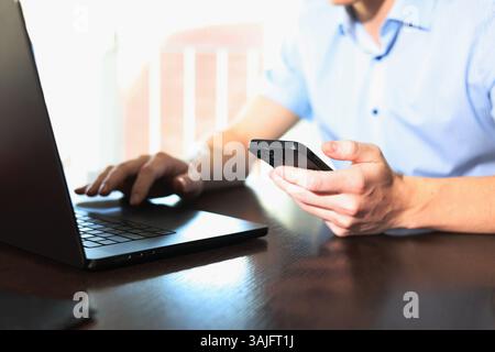 online meeting, man sitting in front of laptop and talking with team members Stock Photo
