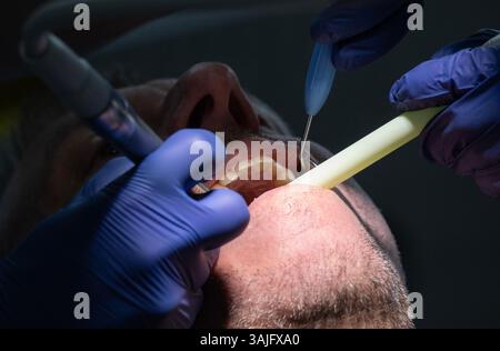 Dentist examines a man's teeth at a dental clinic.Photo: Fredrik Sandberg / TT / Code 10080 Stock Photo