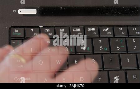 Ghost hand touching computer keyboard Stock Photo