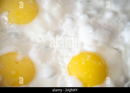 Background. Three fried eggs in closeup Stock Photo