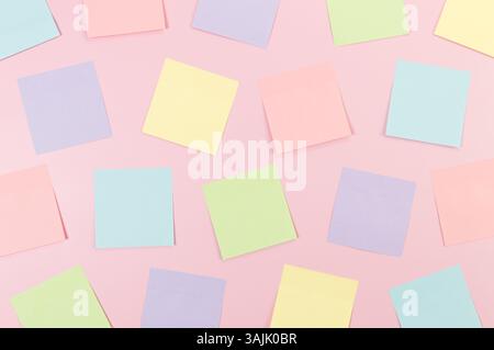 Top view of colorful sticky notes on pink background. School, office wallpaper. Flat lay, copy space. Stock Photo