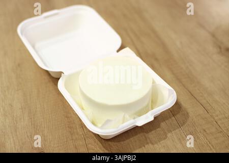 A white cake with space for text. Wooden background Stock Photo
