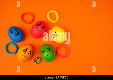 Funny and colorful Easter eggs with different emotions drawn on them, perfect for fun holiday decor. Stock Photo