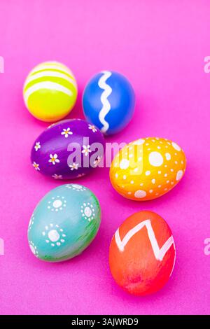 Colorful Designed Easter Eggs Arranged Neatly On Light Pink Background. A set of painted Easter eggs placed in a clean row over a soft pink surface, b Stock Photo