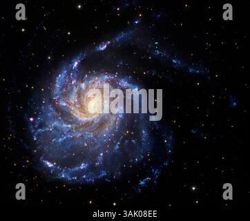 Spiral galaxy M101, composite image. M101 is also known as the Pinwheel Galaxy. It lies around 25 million light years from Earth in the constellation Ursa Major. The disc of the galaxy is some 170,000 light years across, nearly twice as wide as our own Milky Way. The spiral arms appear blue as they contain hot young stars. The central nucleus is yellow as the stars there are older, and much of the light is obscured by dust. Image data from 8.2 Meter Subaru Telescope (NAOJ) and the Hubble Space Telescope. Stock Photo
