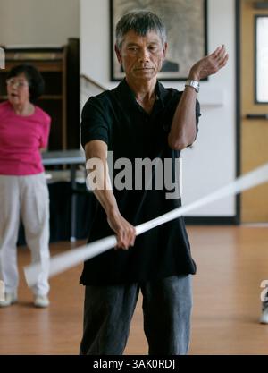 May 23, 2009,  Linda Vista, California, CHIEU HOANG, in front, with other participants, go through warm up exercises at the Bayside Community Center's tai chi class. Classes are twice a week and have both senior citizens and local elementary school kids participating together.  A SDSU student group helped develop a funding strategy that subsidizes senior programs. USA. Mandatory photo credit: Peggy Peattie/Union-Tribune//ZUMA Press. (Credit Image: © The San Diego Union Tribune/ZUMA Press) Stock Photo
