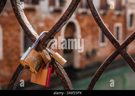 padlocks as a token of love left on a bridge in Venice Stock Photo