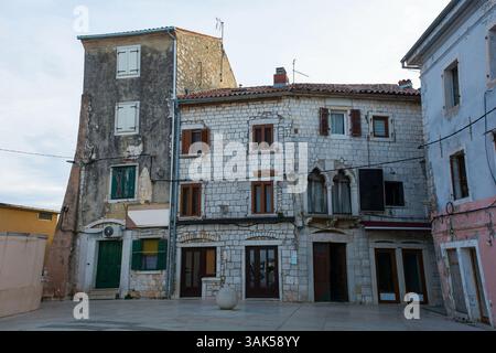 Historic buildings in a small square in Umag in Istria, north west Croatia. 15th-16th century Venetian Gothic transitioning to Renaissance period. Stock Photo