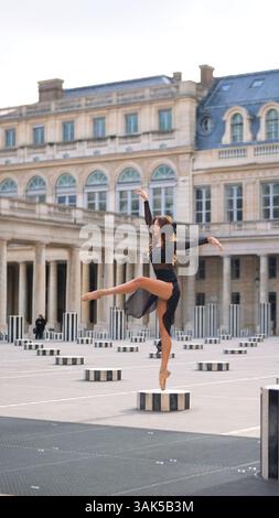 Chic ballet dancer Striking Fashion Pose in Picturesque Paris Courtyard Stock Photo