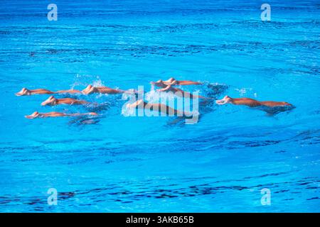 Synchronized or artistic swimmers perform an elegant upside-down ...