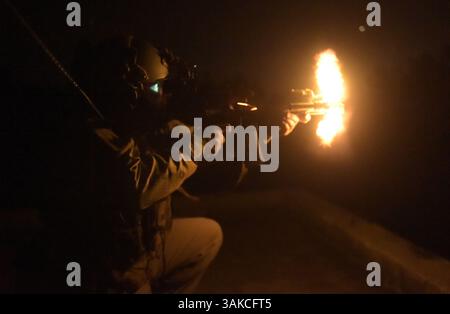 Mar 2, 2017 - Hurlburt Field, Florida, United States - A U.S. Air Force Special Tactics Airman assigned to the 24th Special Operations Wing fires on simulated enemy positions during Emerald Warrior 17 at Eglin Air Force Base, Fla., March 2, 2017. Emerald Warrior is a U.S. Special Operations Command exercise during which joint special operations forces train to respond to various threats across the spectrum of conflict. 1st Combat Camera Squadron (Credit Image: © Barry Loo/U.S. Air Force /DOD/ZUMAPRESS.com) Stock Photo