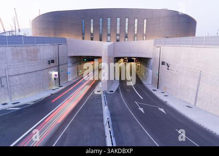 Heavy northbound traffic contrasts with light southbound flow at Silvertown Tunnel southern entrance, showing directional usage patternsEngland UK Stock Photo