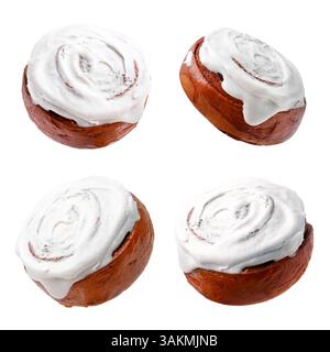 Tasty cinnamon rolls with cream in air on white background Stock Photo