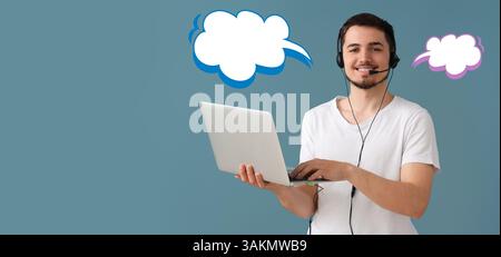 Male technical support agent with laptop and blank speech bubbles on blue background with space for text Stock Photo