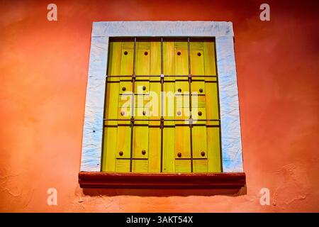 Vibrant Lime Green Shutters on Terracotta Wall Eye-Level Perspective Stock Photo