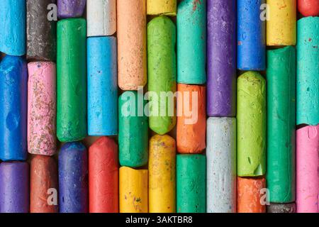 multicolored used oil pastel crayons arranged, old half used wax crayons pieces in close-up view, taken straight from above Stock Photo