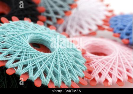 Many bobbins with different colored threads for sewing Stock Photo