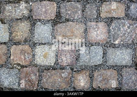 Color paving square blocks old dark grey concrete wall texture background Stock Photo
