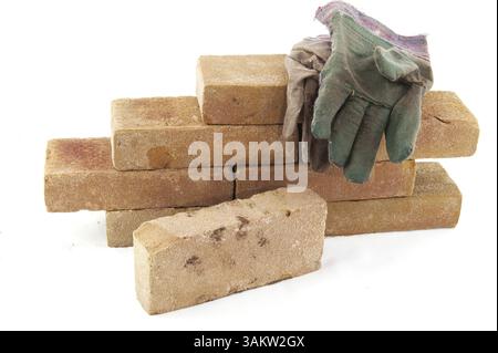Building a wall with many bricks isolated over white Stock Photo