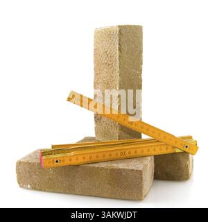 Bricks and measurement tool isolated over white Stock Photo