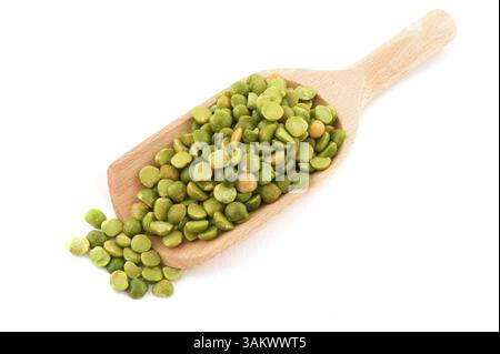 Green broken peas on wooden spoon isolated over white background Stock Photo